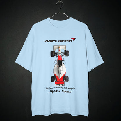 Light blue t-shirt with McLaren Formula 1 car graphic on a dark background