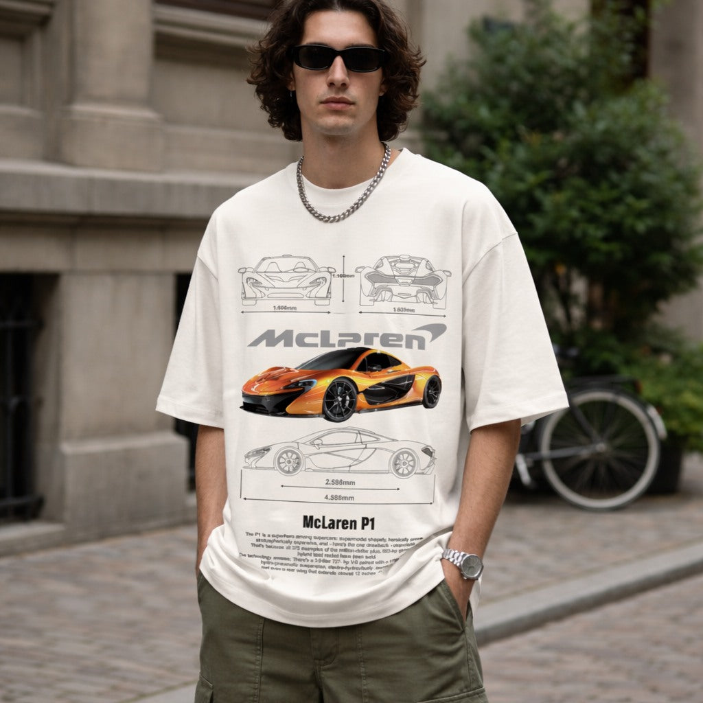 Person wearing a white t-shirt with McLaren P1 design outdoors.