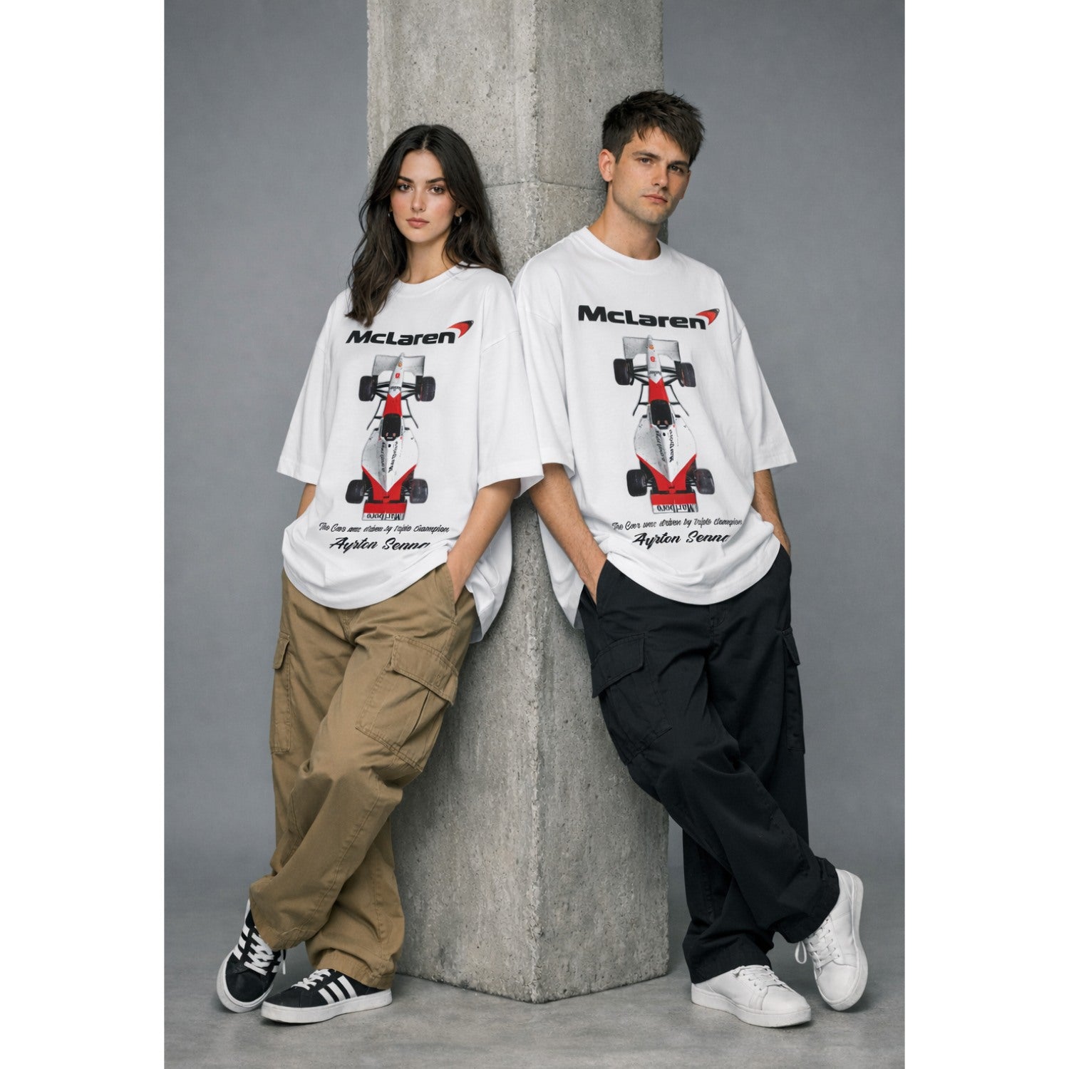 Two people wearing McLaren t-shirts with a race car graphic against a gray background