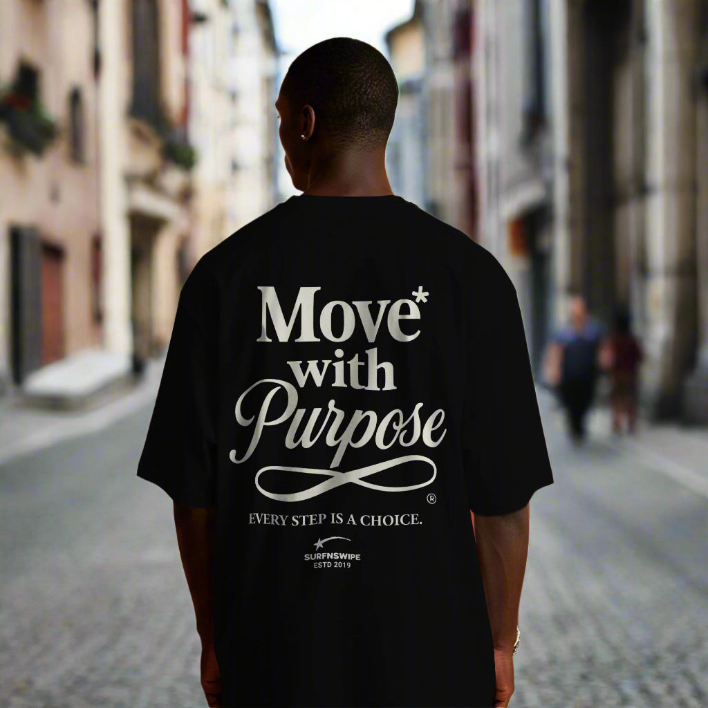 Person wearing a black t-shirt with 'Move with Purpose' text in a colorful room.