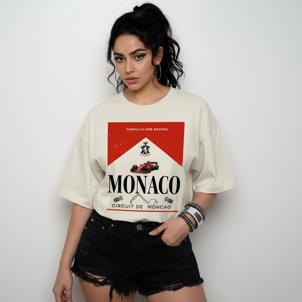 Woman wearing a t-shirt with Monaco racing design on a plain background