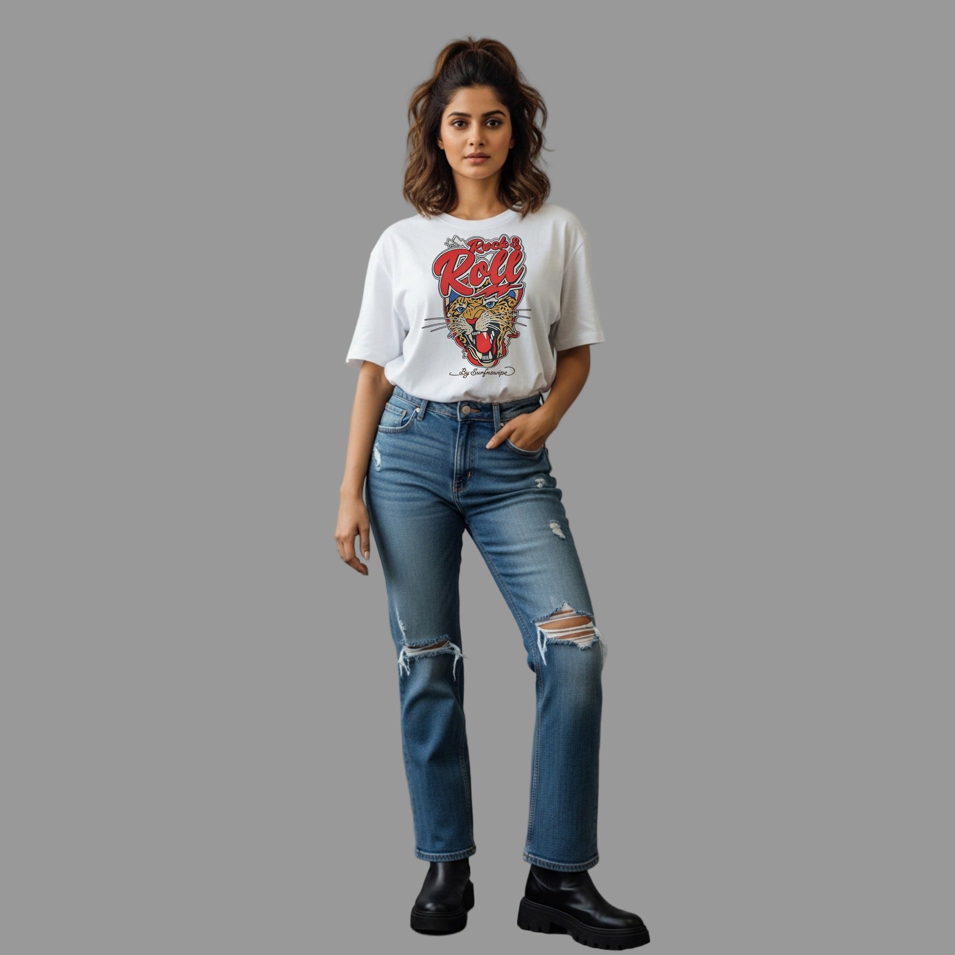 Woman wearing a white t-shirt with a graphic design and blue jeans against a gray background