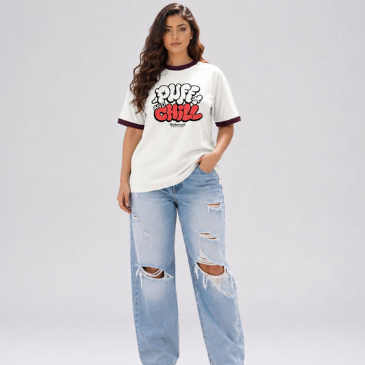 Woman wearing a white t-shirt with red and black text and ripped jeans on a gray background