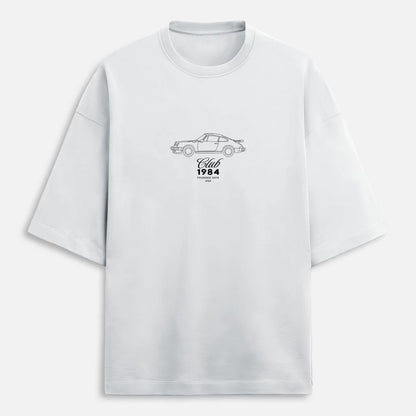 White t-shirt with car graphic and text on a white background