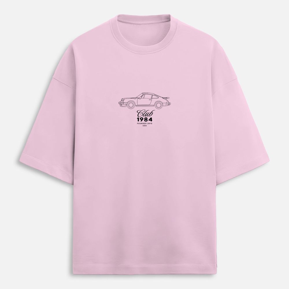 Pink t-shirt with a car graphic and text on a white background