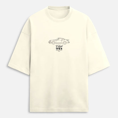 Beige t-shirt with a car graphic and text on a light gray background