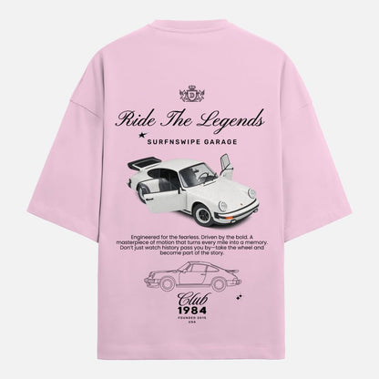 Pink t-shirt with car graphics and text on a white background