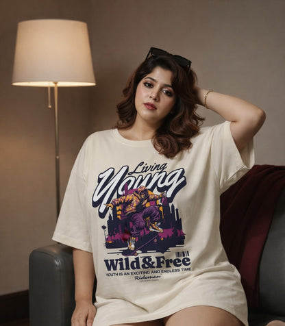 Woman wearing a white t-shirt with a graphic design sitting on a couch.