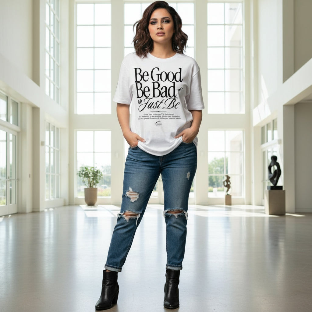 Woman wearing a white t-shirt with text and ripped jeans in an indoor setting