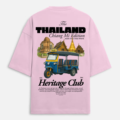 Pink t-shirt with a graphic of a tuk-tuk and temple, featuring text about Thailand and Chiang Mi.