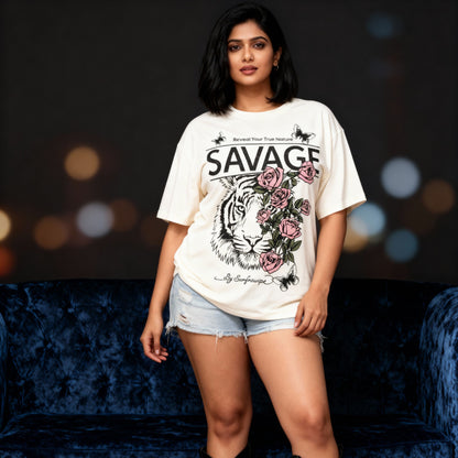 Woman wearing a 'Savage' t-shirt with a tiger and floral design on a dark background.