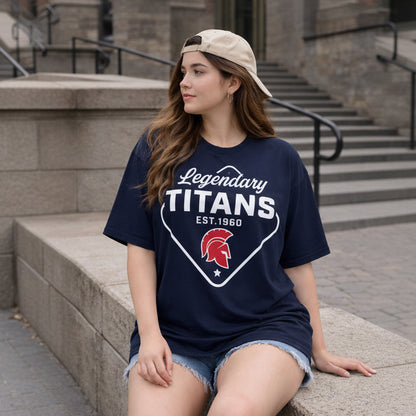 Woman wearing a navy blue t-shirt with 'Legendary Titans' design, sitting on steps.
