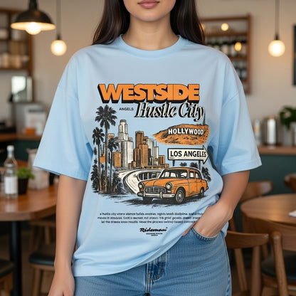 Person wearing a light blue t-shirt with a graphic design of Los Angeles and text.