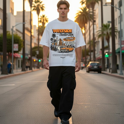 Person wearing a 'Westside Hustle City' t-shirt walking on a city street with palm trees.