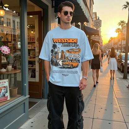 Man wearing a 'Westside Hustle City' t-shirt on a city street.