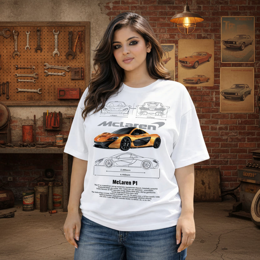 Woman wearing a white t-shirt with McLaren car design, standing outdoors with a fountain in the background.