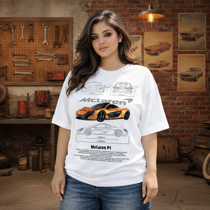 Woman wearing a white t-shirt with McLaren car design, standing outdoors with a fountain in the background.