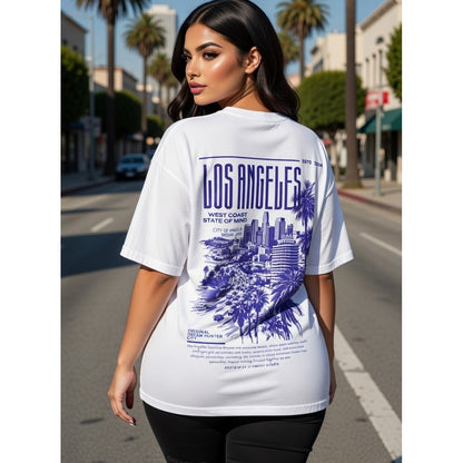 Woman wearing a white t-shirt with 'Los Angeles' design on a city street.