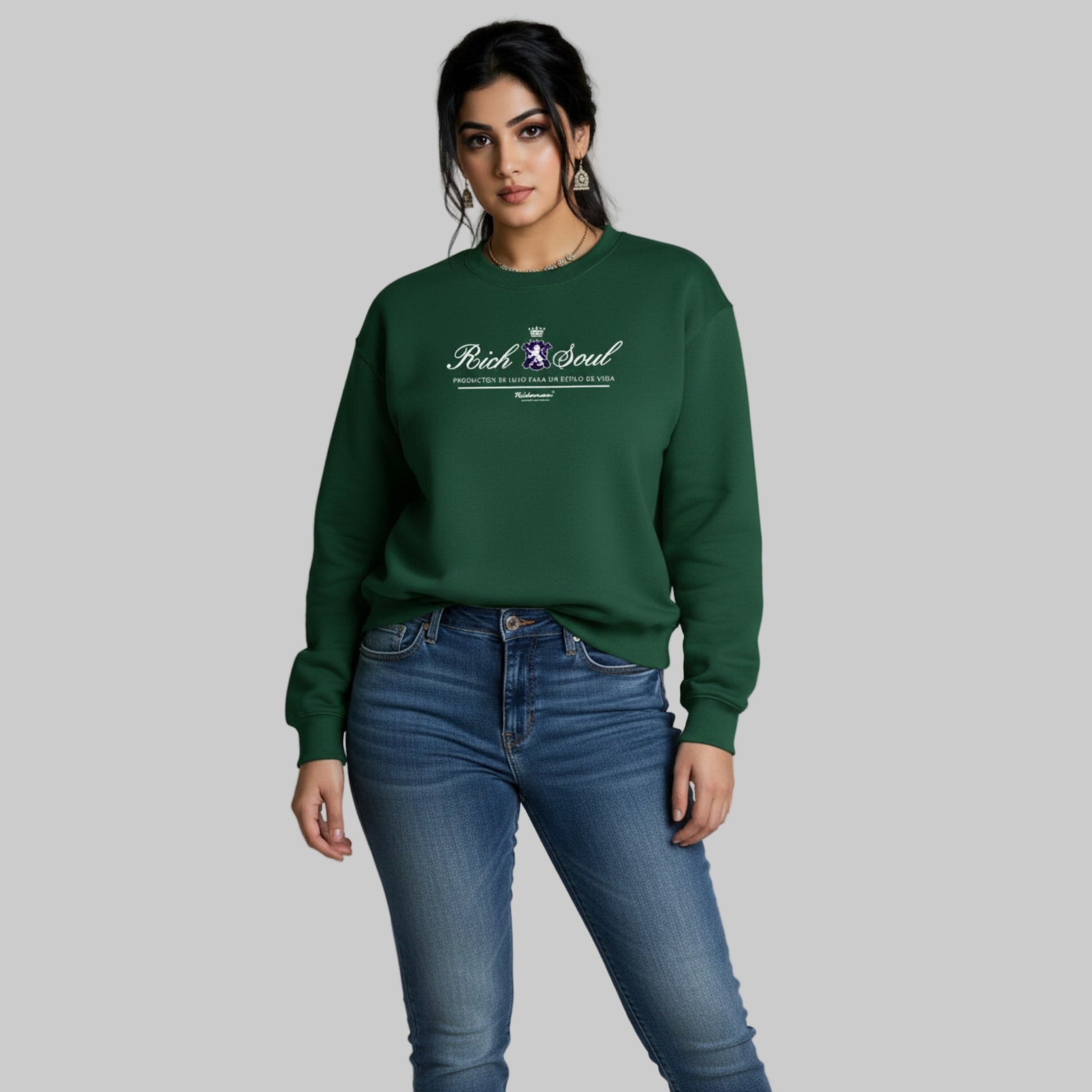 Woman wearing a green sweatshirt with a logo and text, standing against a plain background