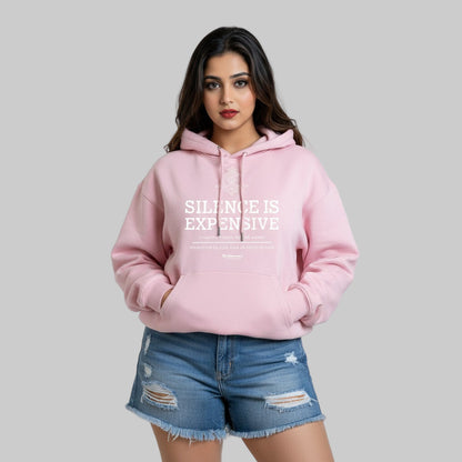 Woman wearing a pink hoodie with 'SILENCE IS EXPENSIVE' text on a white background