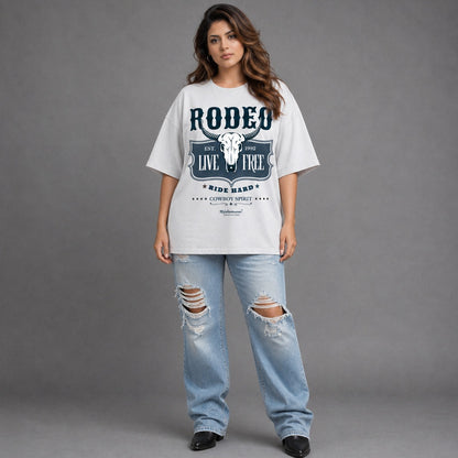 Woman wearing a white 'Rodeo' t-shirt and ripped jeans on a gray background