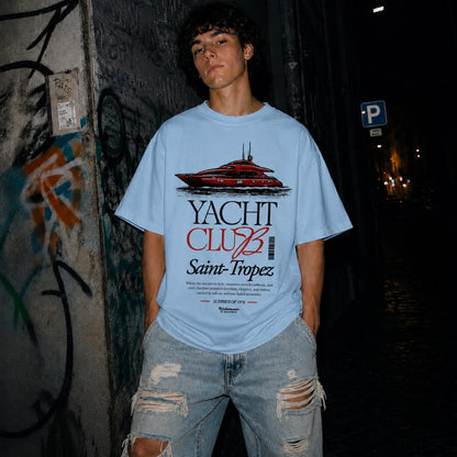 Man wearing blue Yacht Club Saint-Tropez oversized tee with ripped denim jeans