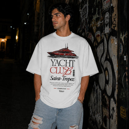 Man wearing white Yacht Club Saint-Tropez oversized tee with ripped denim jeans