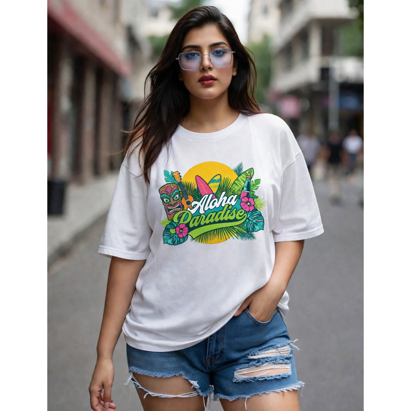Woman wearing a white t-shirt with 'Aloha Paradise' design on a city street.