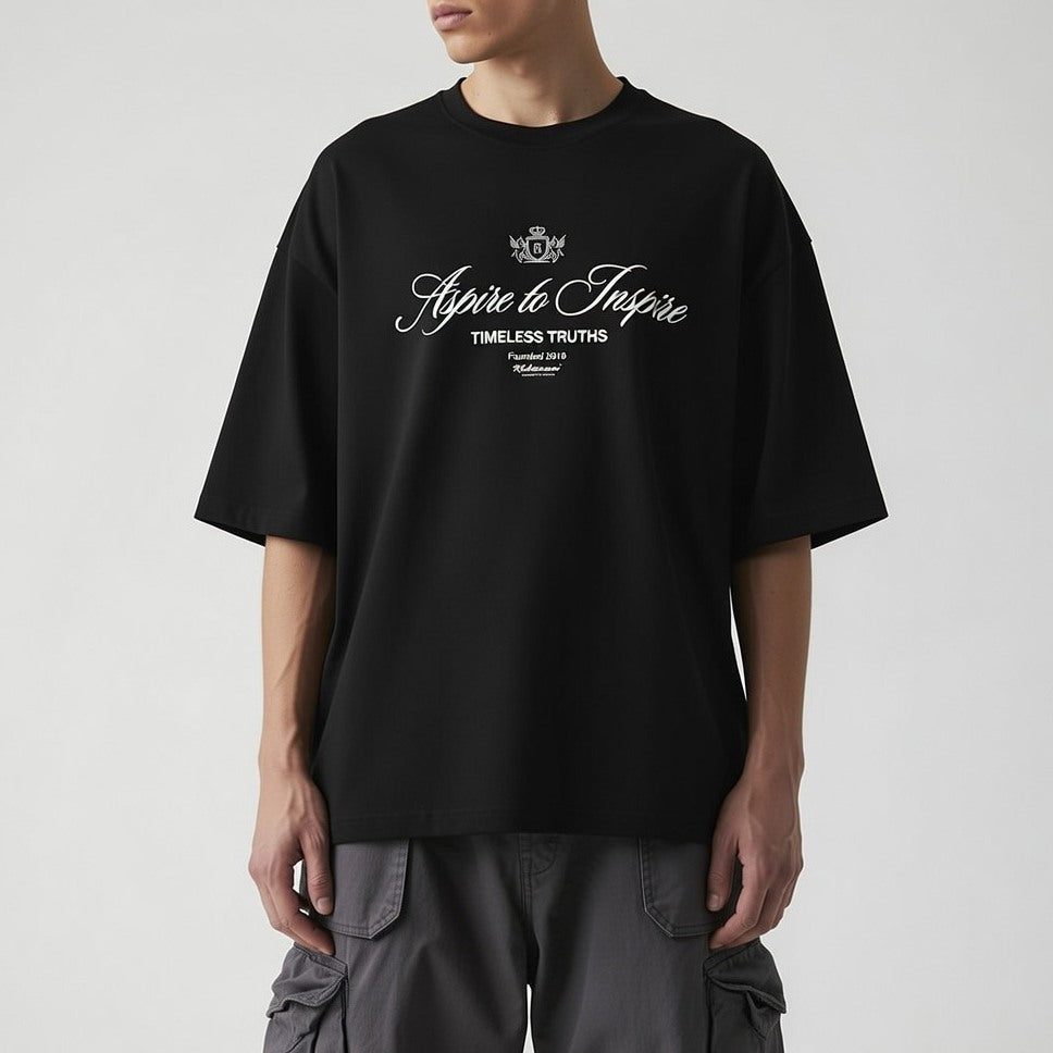 Person wearing a black t-shirt with text on a plain background