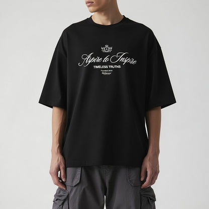 Person wearing a black t-shirt with text on a plain background