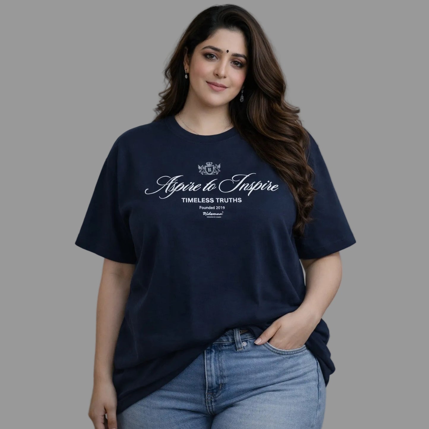 Woman wearing a navy blue t-shirt with text on a gray background