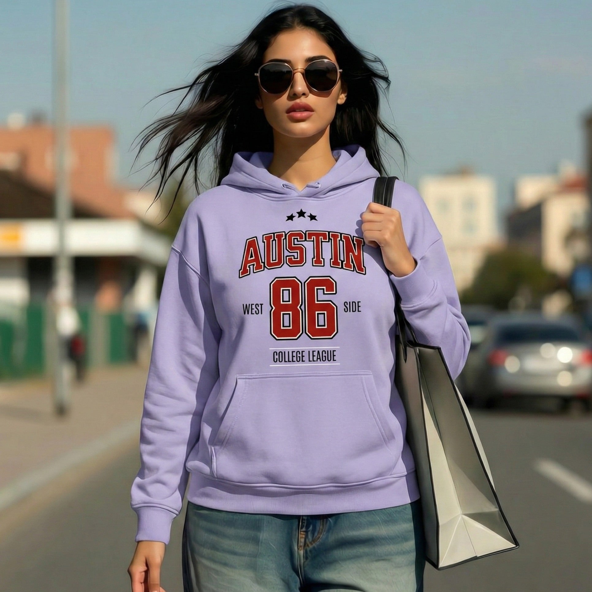 Woman wearing a purple hoodie with 'Austin 86' text, walking outdoors.