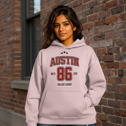 Person wearing a light purple hoodie with 'Austin 86' text, standing outdoors.