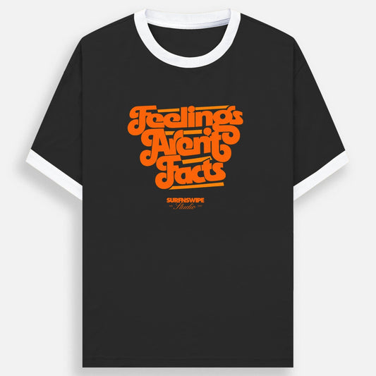 A black ringer t-shirt with a white crew neck and white sleeve cuffs, featuring a retro orange graphic on the chest that reads 'Feelings Are Facts' with 'SURFNSWIPE Apparel' printed below it.