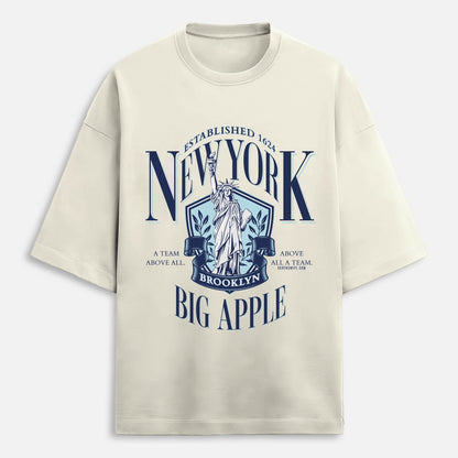 Beige t-shirt with New York-themed graphic design on a white background