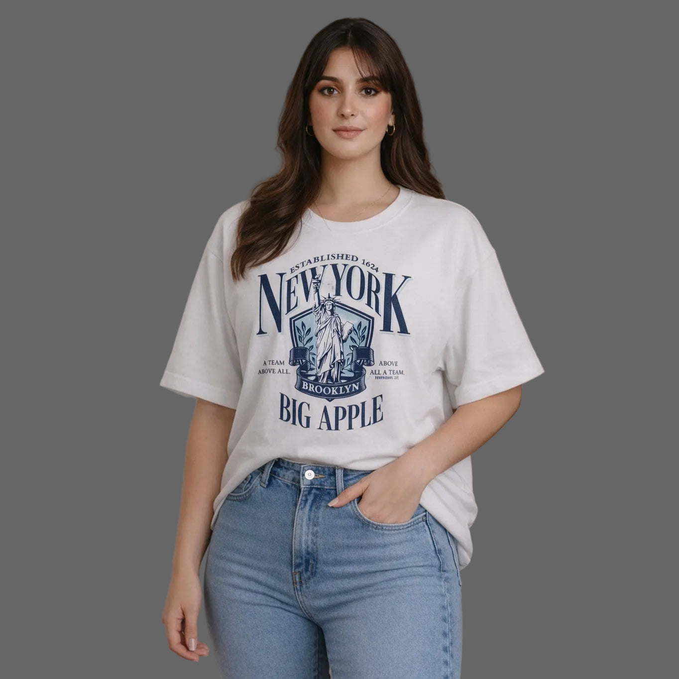 Woman wearing a white t-shirt with 'New York Big Apple' design and blue jeans.