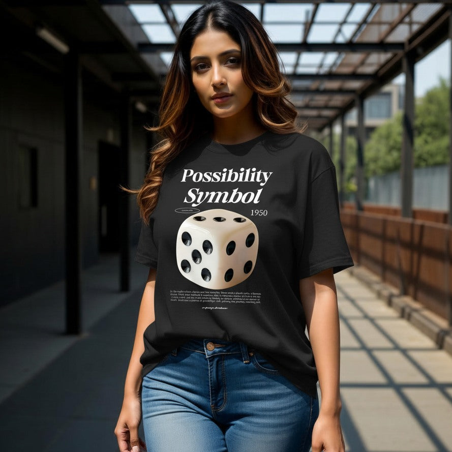 Woman wearing a black t-shirt with a dice design and text in an outdoor setting