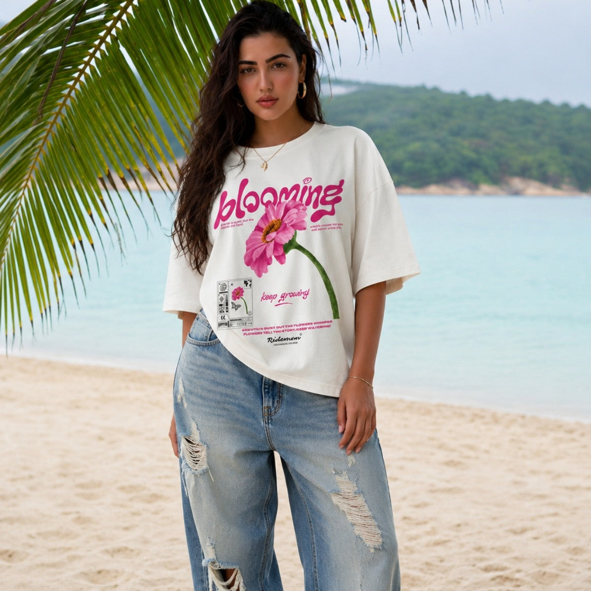 Woman wearing a 'blooming' t-shirt on a beach