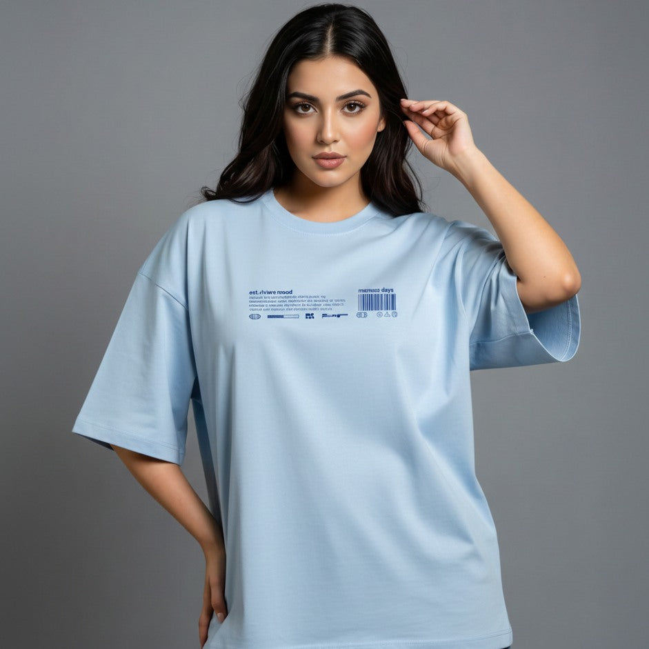 Woman wearing a light blue t-shirt with a label on a gray background