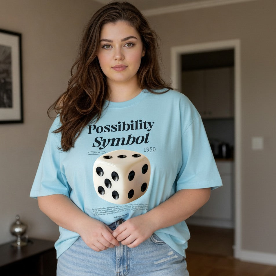 Woman wearing a light blue t-shirt with a dice graphic and text in a room.