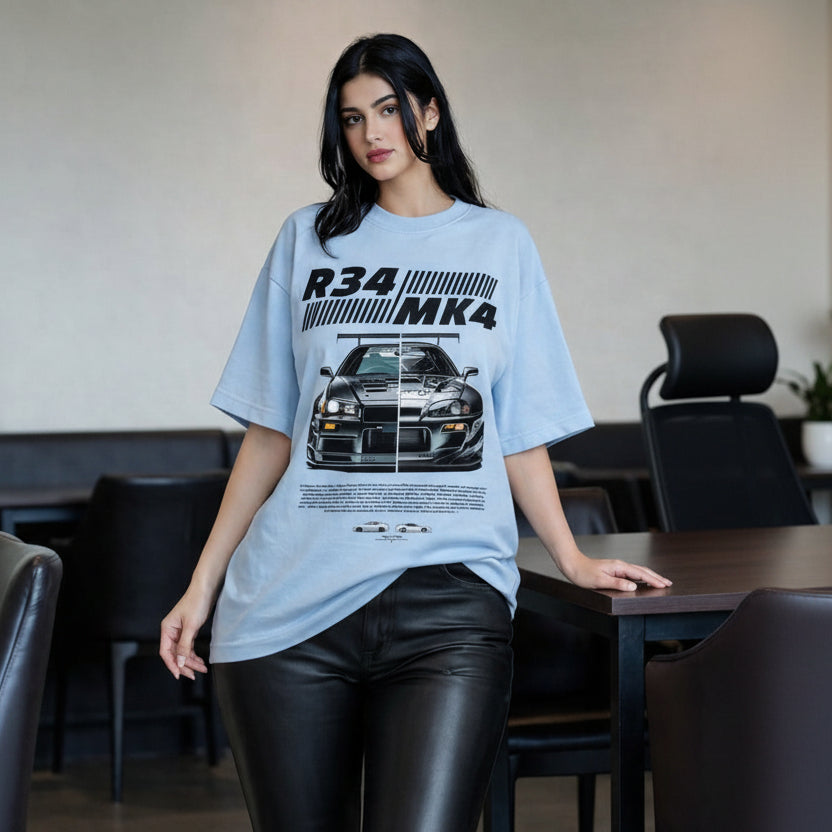 Woman wearing a light blue t-shirt with car graphic and text in a casual setting.