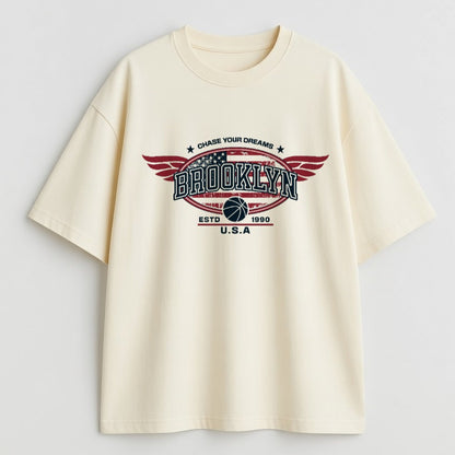 Beige t-shirt with 'Brooklyn' graphic design on a light gray background