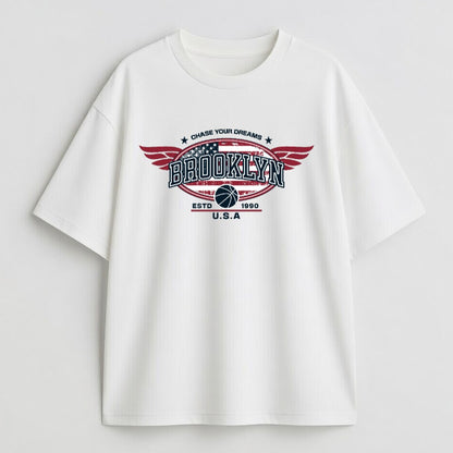 White t-shirt with 'Brooklyn' graphic design on a light gray background
