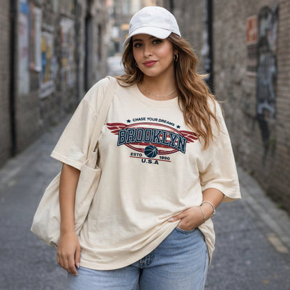 Woman wearing a 'Brooklyn' t-shirt with a cap in an urban setting