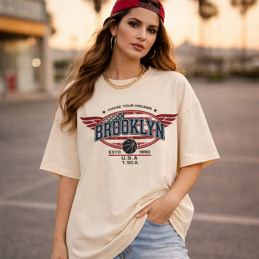 Woman wearing a 'Brooklyn' t-shirt in an outdoor setting