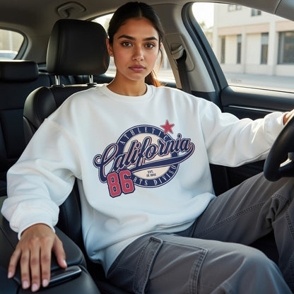 Person wearing a white sweatshirt with 'California 86' text sitting inside a car.