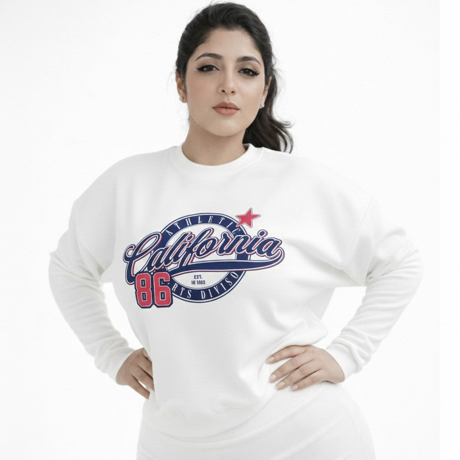 Woman wearing a white sweatshirt with 'California 86' print on a white background