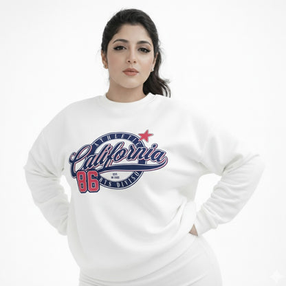 Woman wearing a white sweatshirt with 'California 86' print on a white background