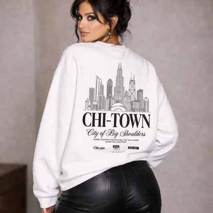 Woman wearing a white sweatshirt with 'CHI-TOWN City of Big Shoulders' design on the back.