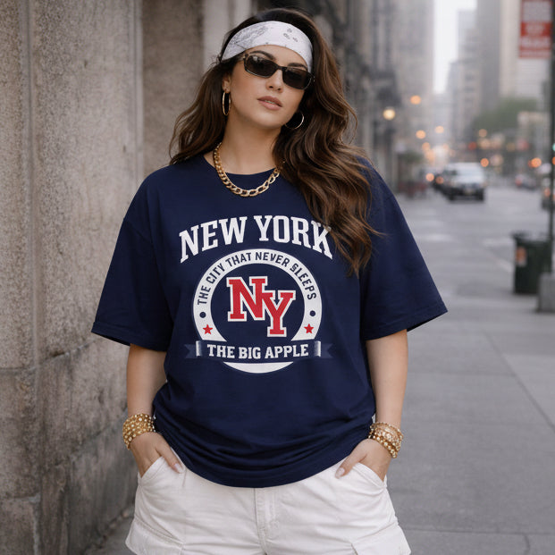 Woman wearing a navy blue 'New York' t-shirt on a city street.